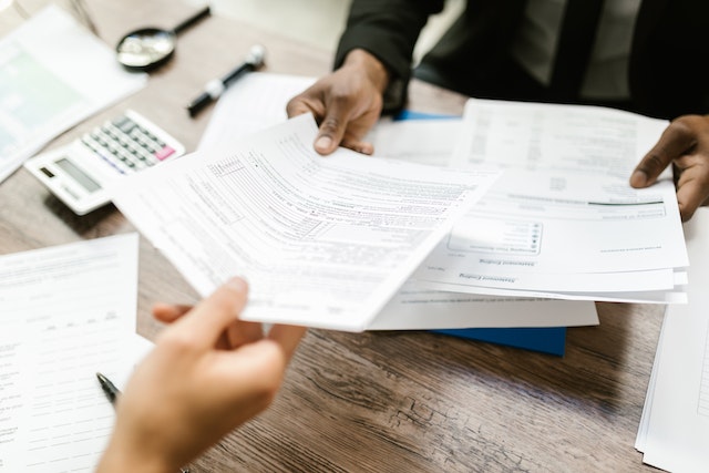 two people exchanging documents